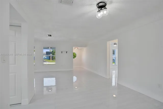 a view of a hallway to a window