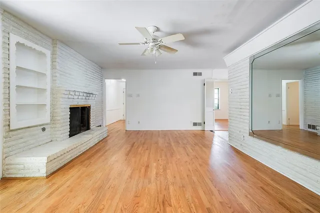 wooden floor in an empty room with a fireplace