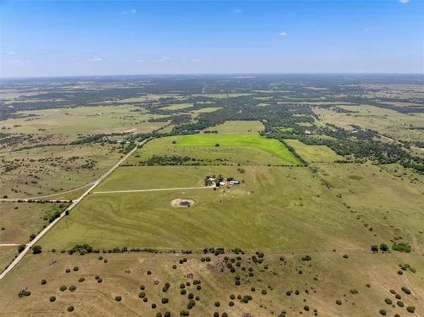 a view of a hallway with wooden shelves