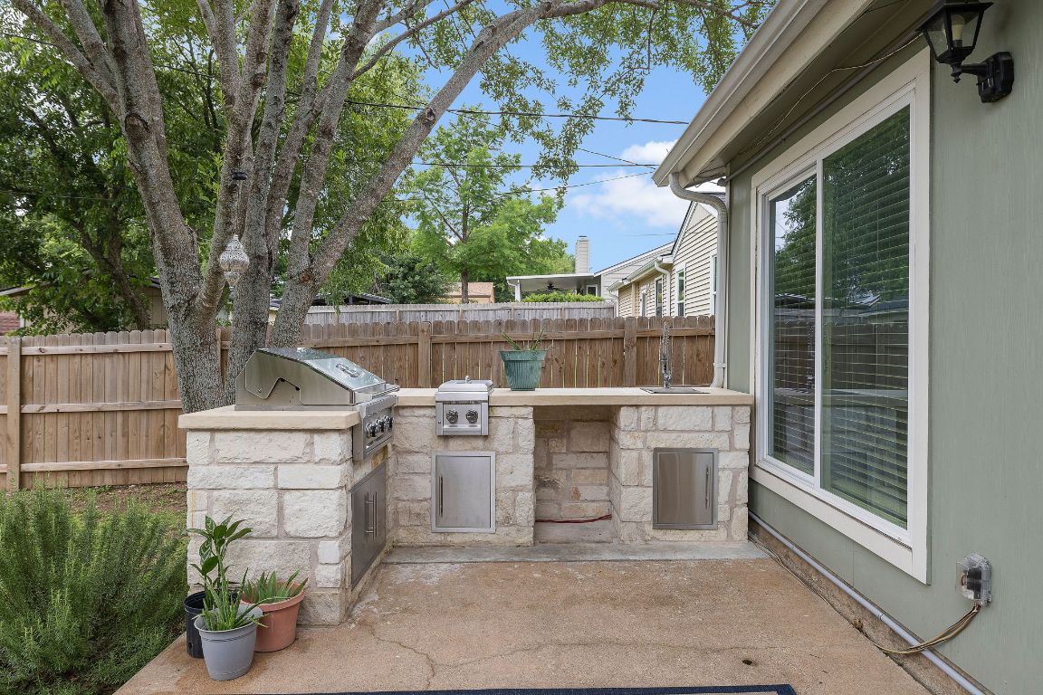 a view of a patio with table and chairs potted plants
