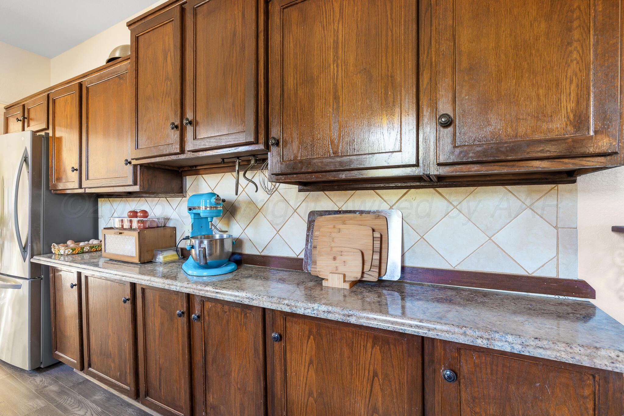 1401 3rd Avenue Canyon, TX 79015 - Photo 20 of 40 a kitchen with granite countertop cabinets and stainless steel appliances