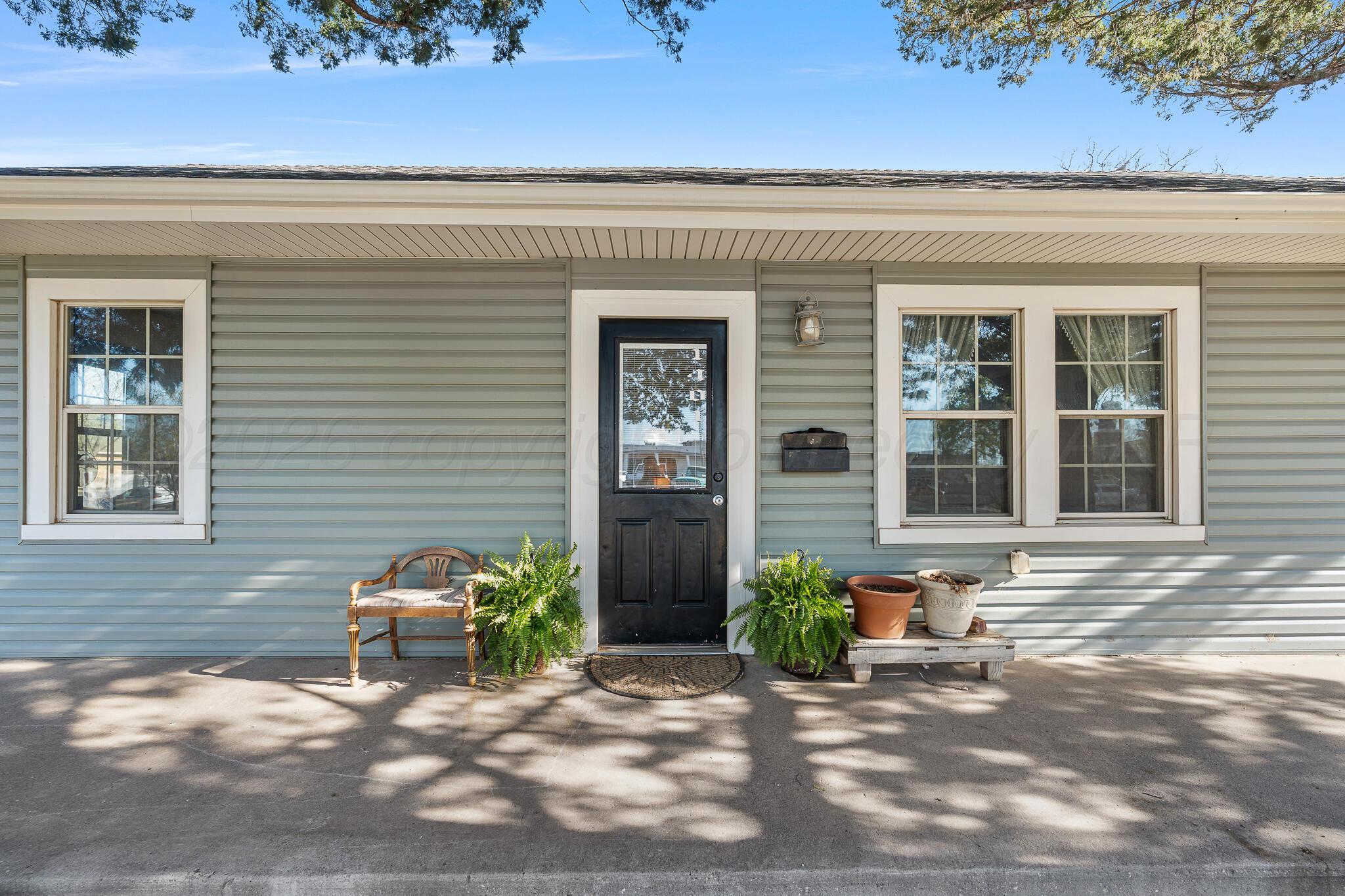 1401 3rd Avenue Canyon, TX 79015 - Photo 2 of 40 a view of a door with a chair and potted plant in front of a house