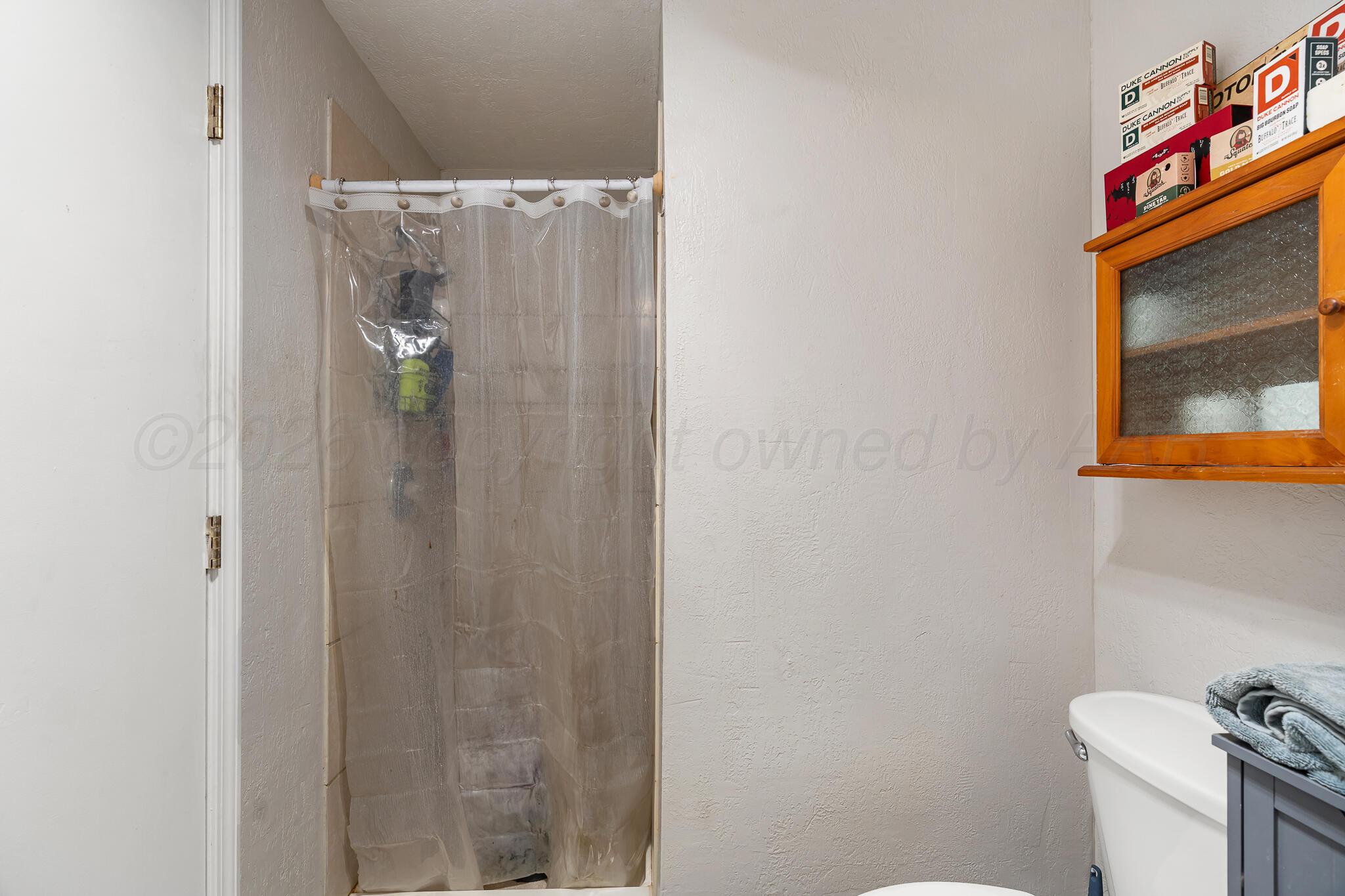 1401 3rd Avenue Canyon, TX 79015 - Photo 26 of 40 a bathroom with a shower and a toilet