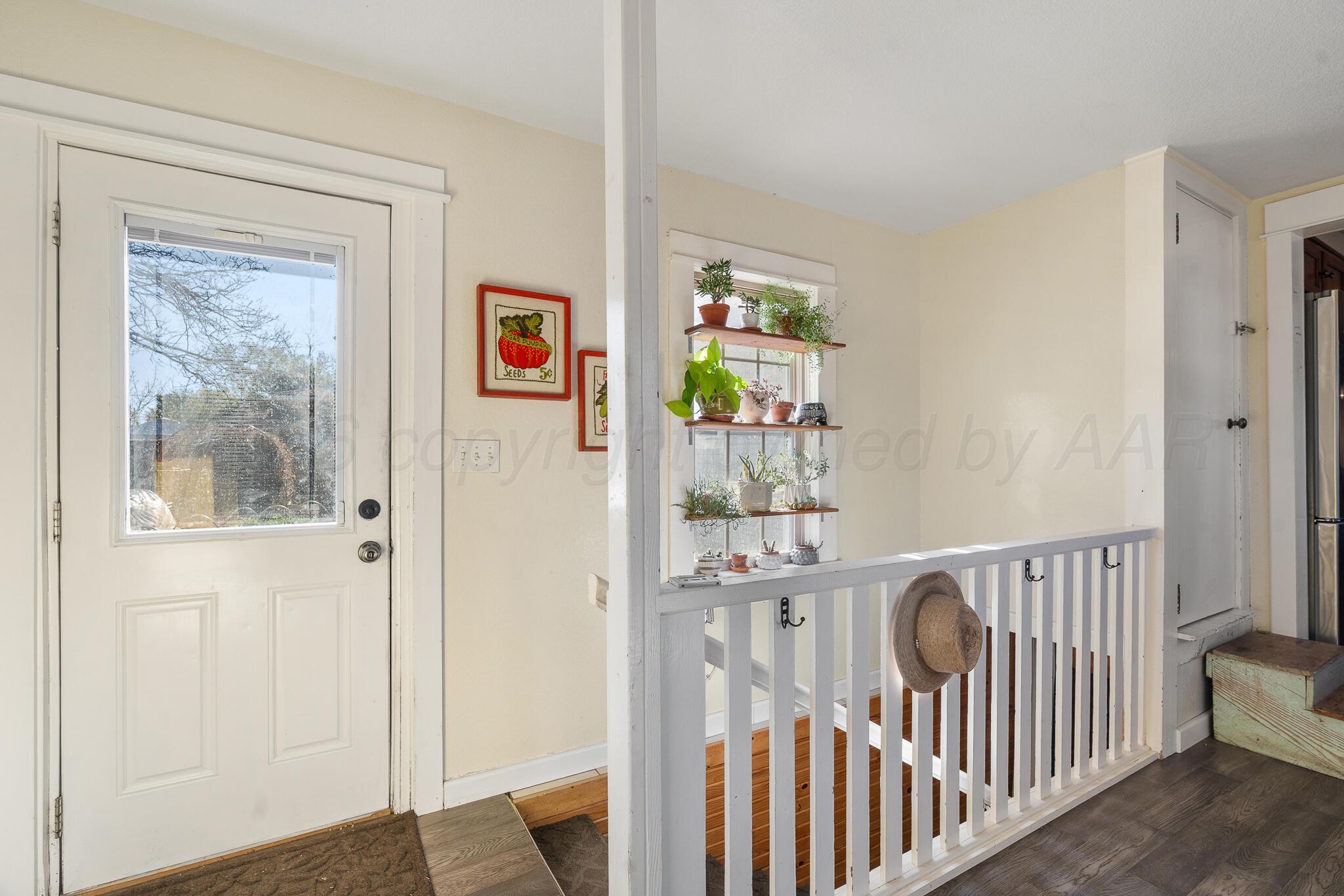1401 3rd Avenue Canyon, TX 79015 - Photo 27 of 40 a view of a hallway with wooden floor and windows