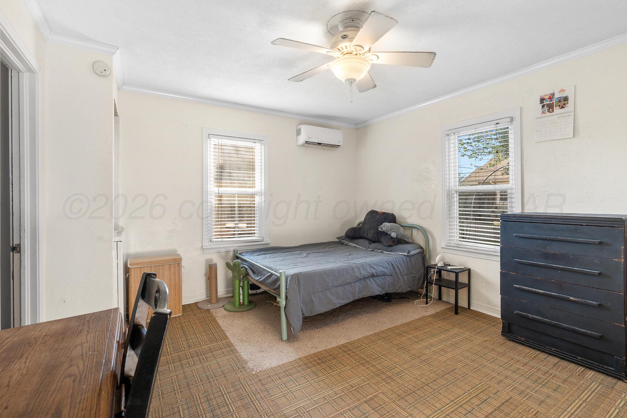 1401 3rd Avenue Canyon, TX 79015 - Photo 36 of 40 a bedroom with a bed and a chandelier