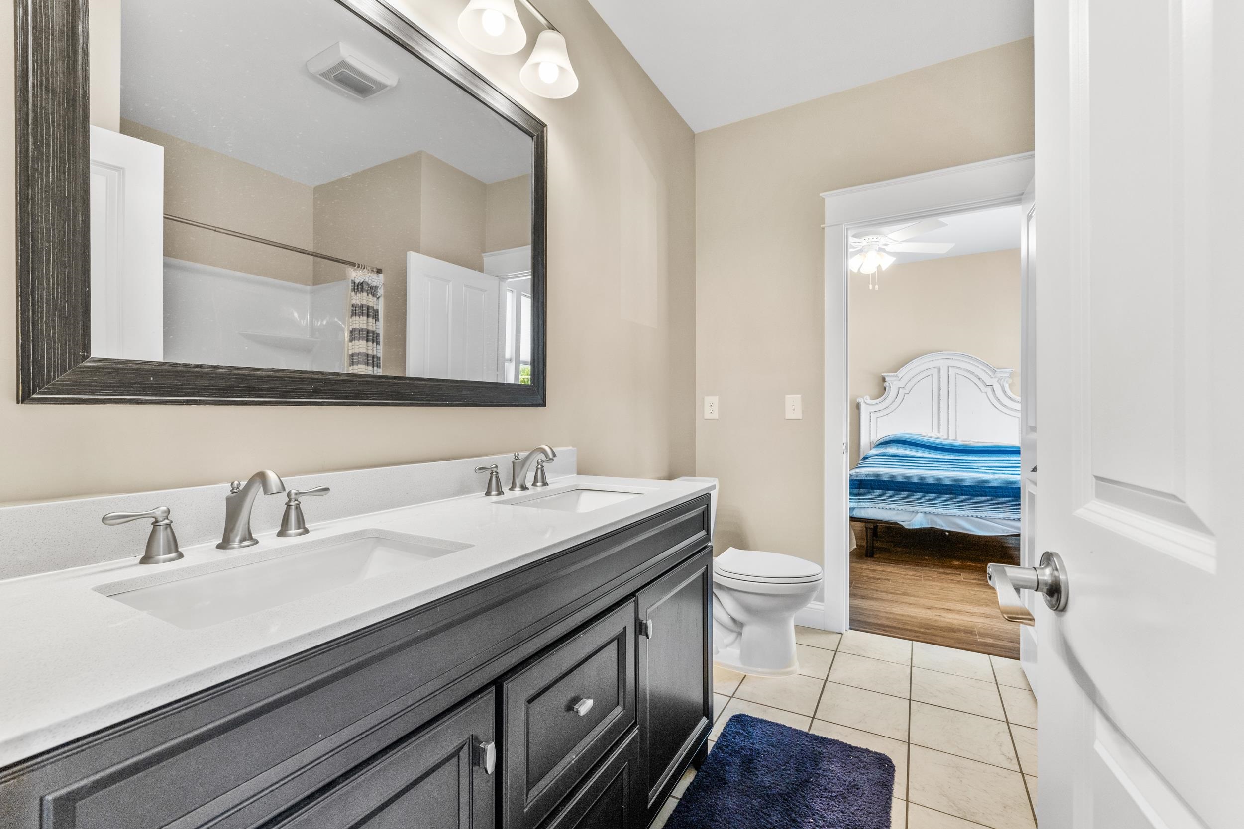 5907 Haskell Circle Myrtle Beach, SC 29577 - Photo 25 of 38 Full bath featuring double vanity, light tile patterned floors, a shower with shower curtain, ensuite bathroom, and ceiling fan