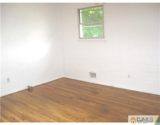 32 Barlow Road Edison, NJ 08817 - Photo 4 of 4 a view of empty room with wooden floor