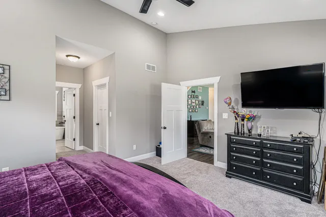 a bedroom with a bed and a flat screen tv