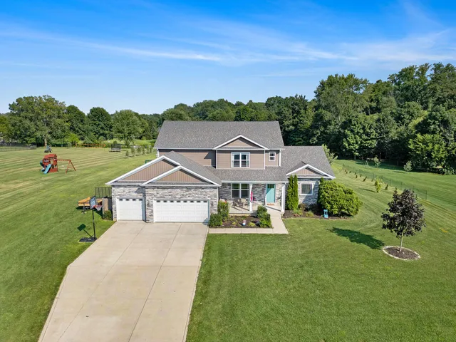 a house with green field in front of it