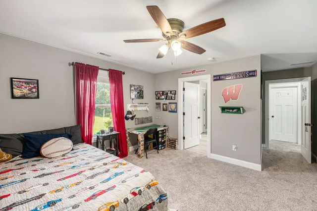 a bedroom that has a bed and a chandelier