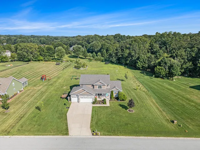 an aerial view of a house with a yard