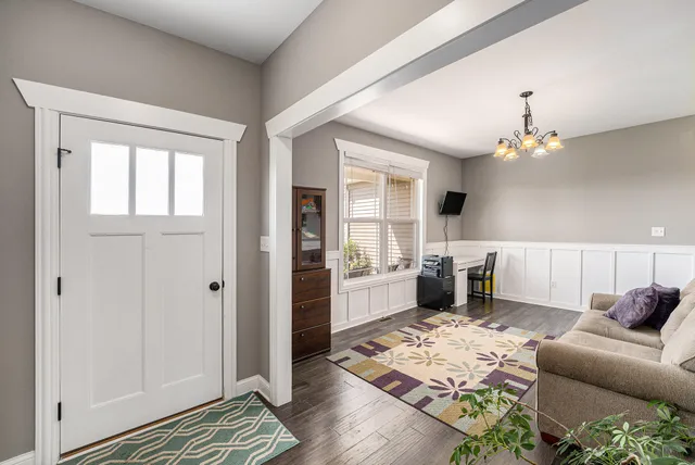 a living room with furniture and a chandelier