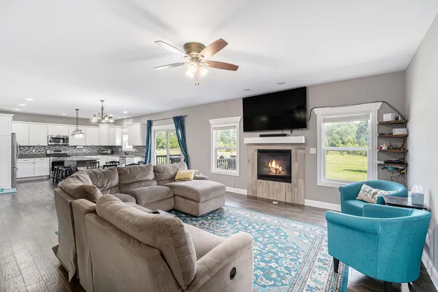 a living room with furniture flat screen tv and a fireplace