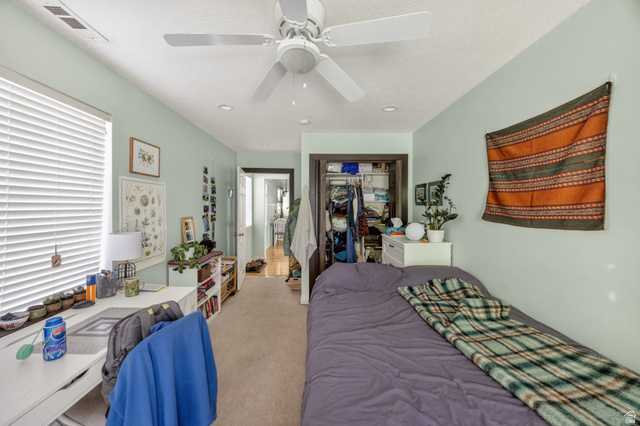 730 East 200 North Logan, UT 84321 - Photo 22 of 28 Bedroom featuring neutral carpeting, a ceiling fan, recessed lighting, a window with horizontal blinds, and a built-in closet with dark trim