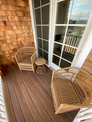 a view of balcony with wooden floor
