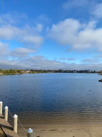 a view of a house with a yard and a wooden fence