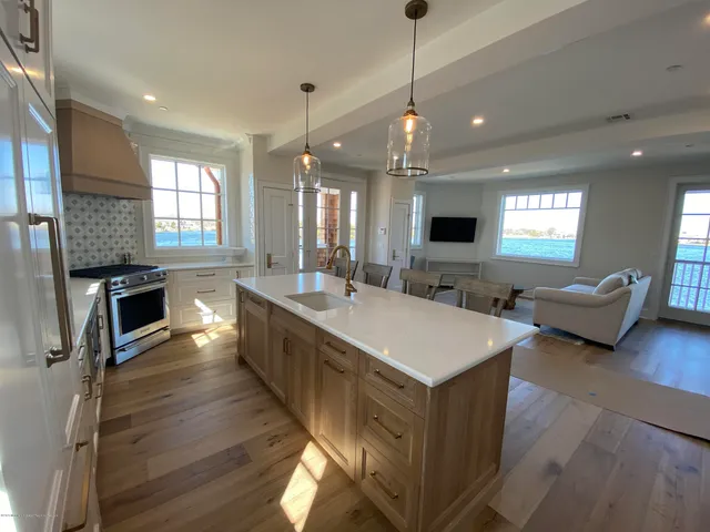 a spacious bathroom with a sink a large mirror and vanity