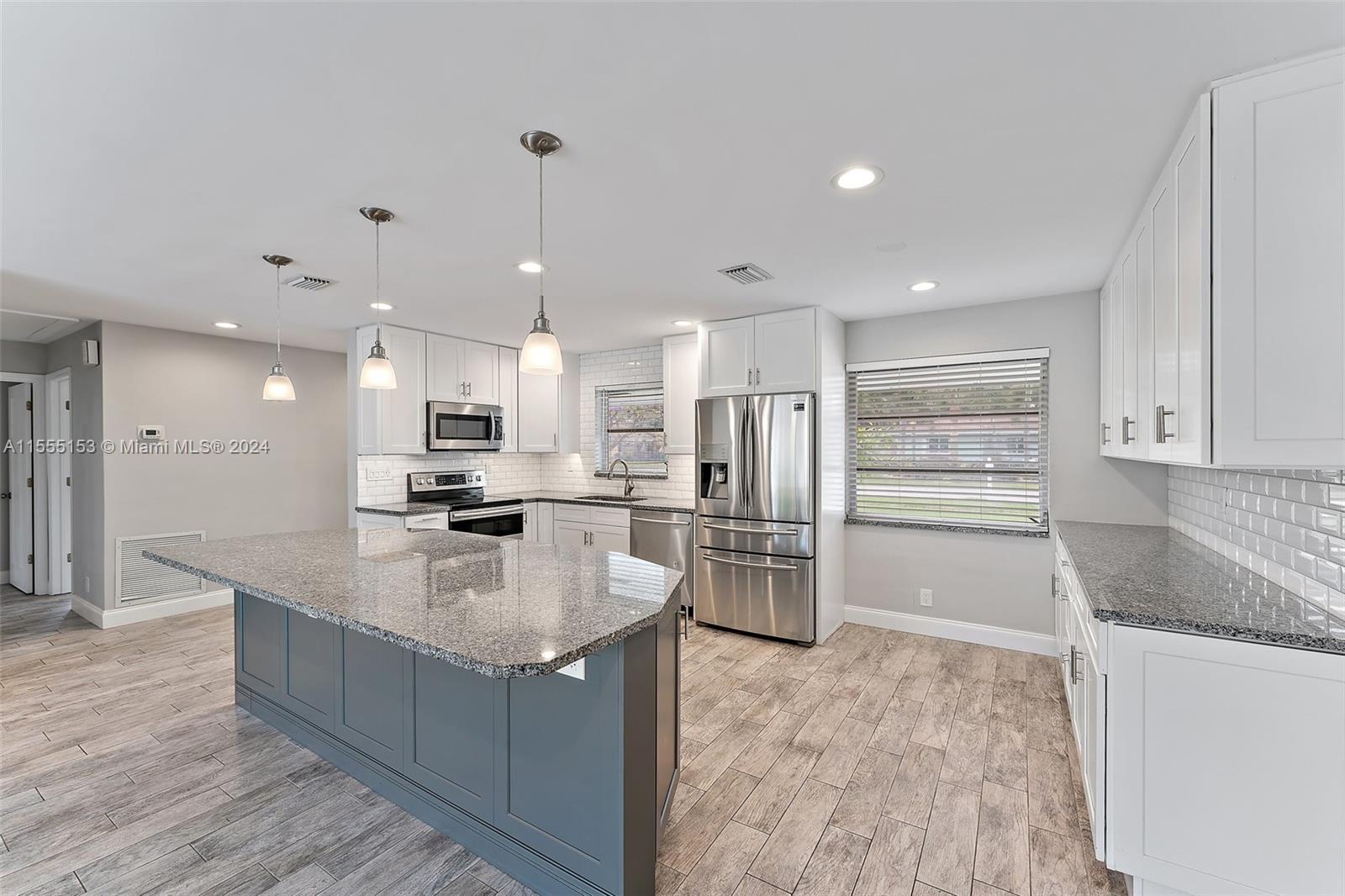538 Dover Road Tequesta, FL 33469 - Photo 11 of 63 a kitchen with stainless steel appliances granite countertop a refrigerator and a sink