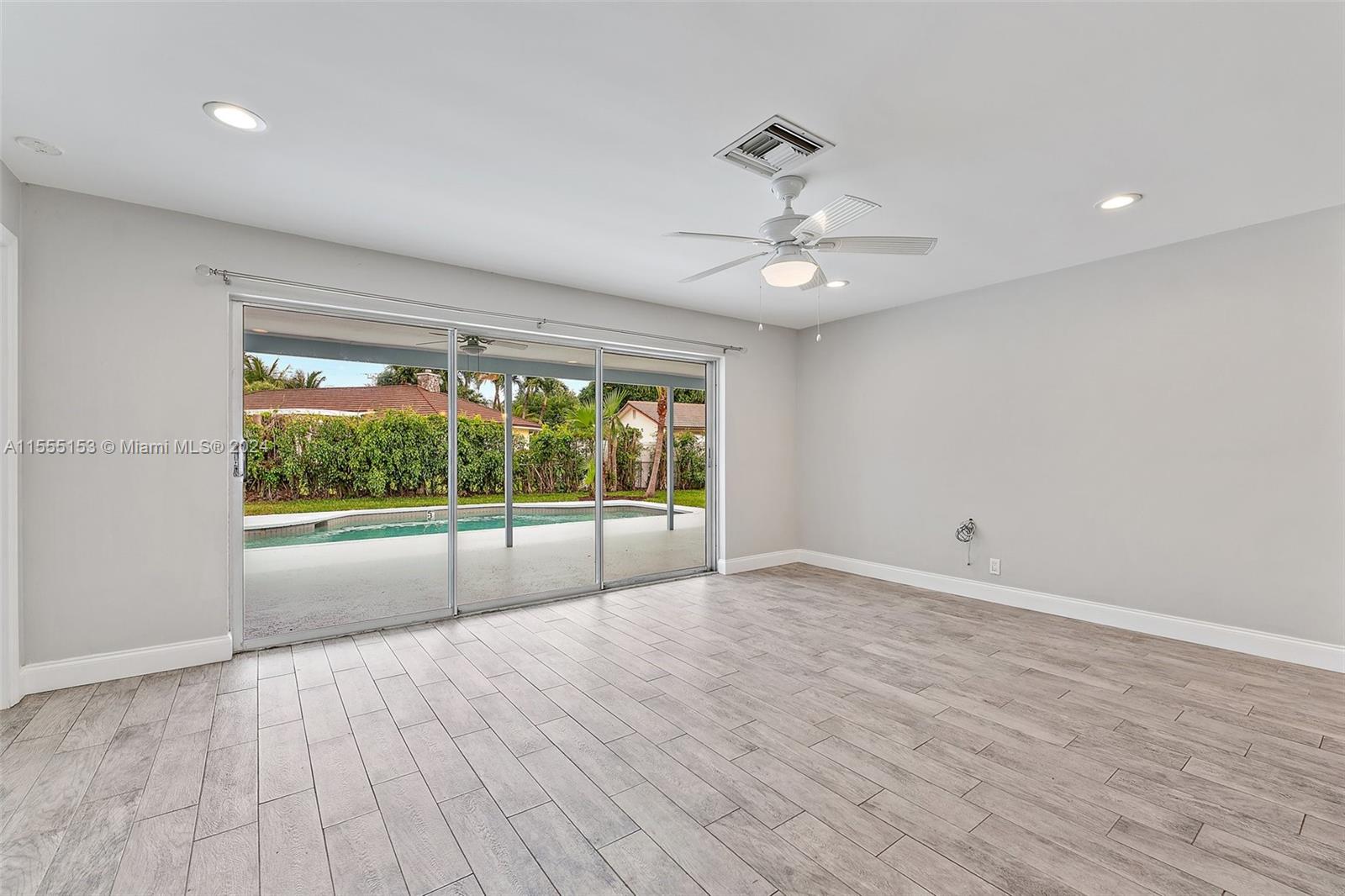 538 Dover Road Tequesta, FL 33469 - Photo 18 of 63 a view of an empty room with a window and wooden floor