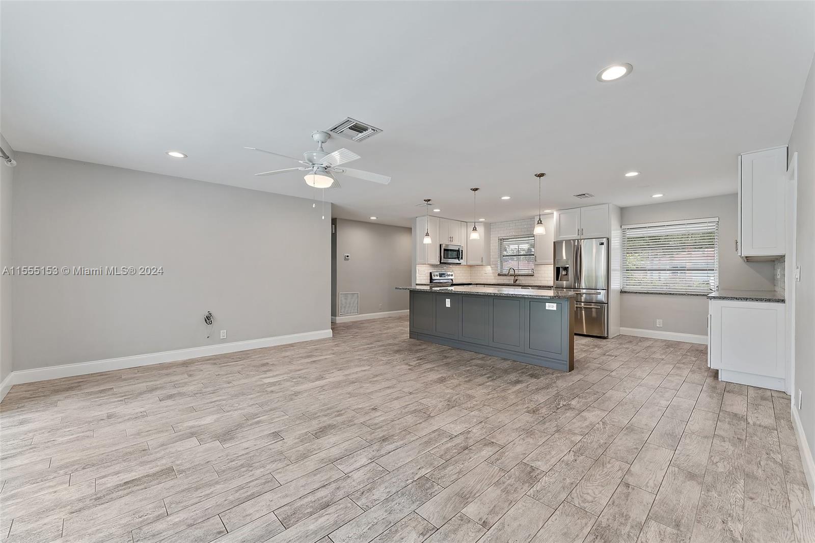 538 Dover Road Tequesta, FL 33469 - Photo 20 of 63 a large kitchen with kitchen island a stove a refrigerator a sink dishwasher with a dining table and chairs