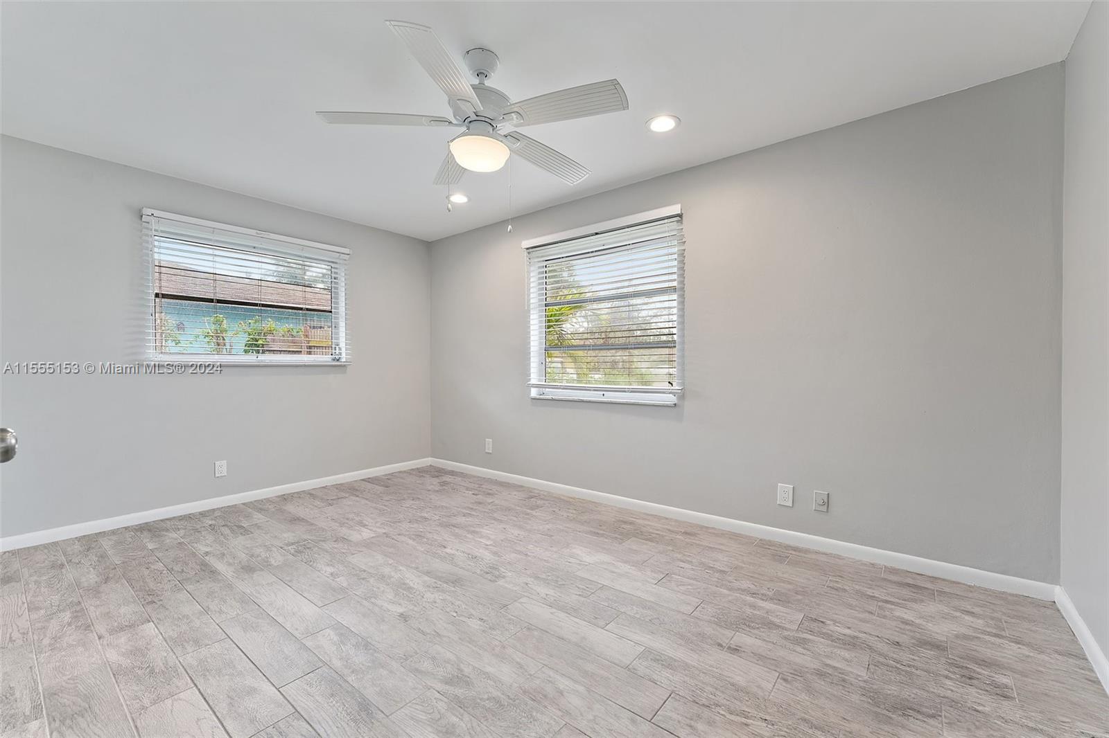 538 Dover Road Tequesta, FL 33469 - Photo 28 of 63 an empty room with windows and fan