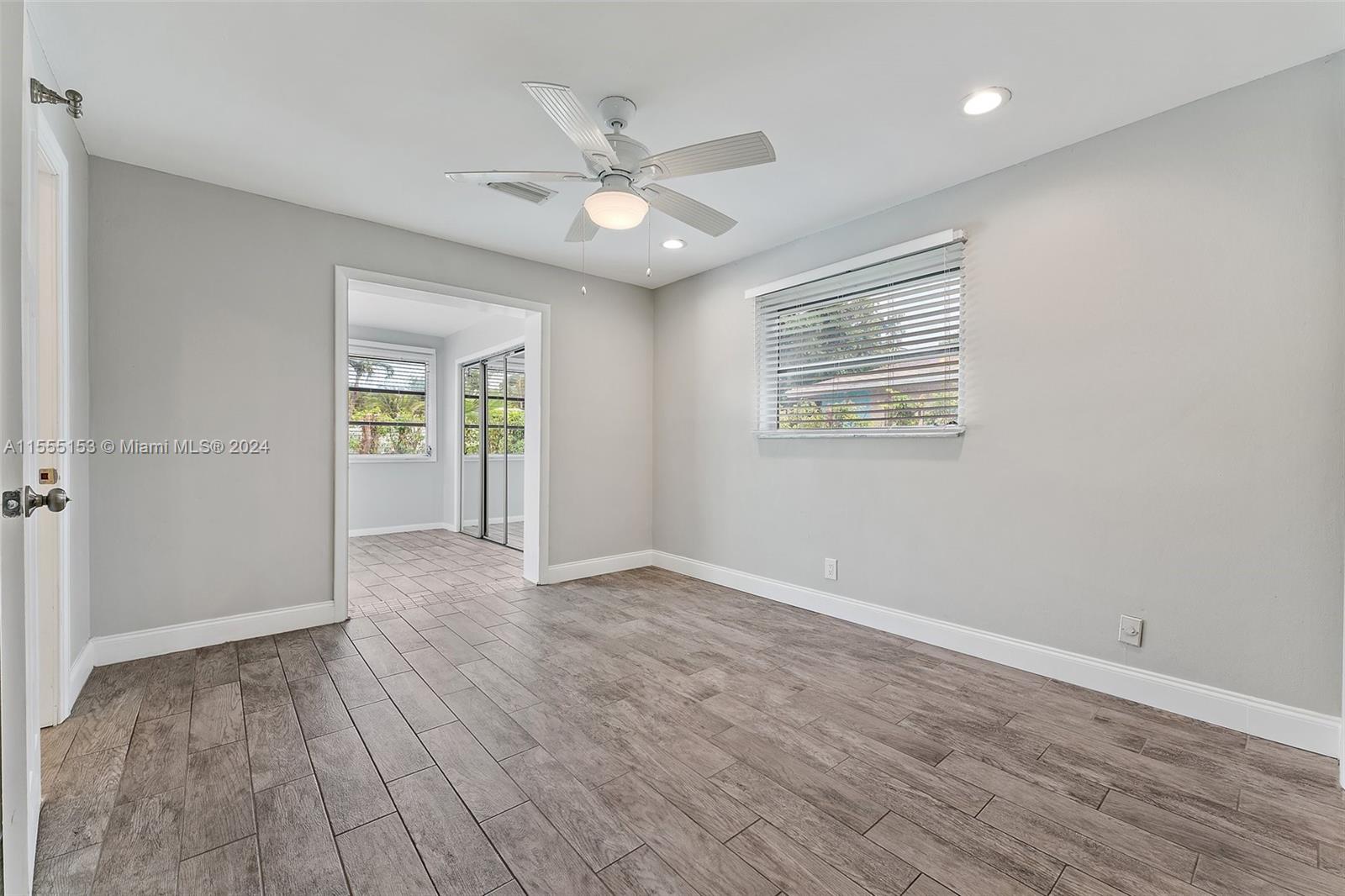 538 Dover Road Tequesta, FL 33469 - Photo 32 of 63 a view of an empty room with wooden floor and a window