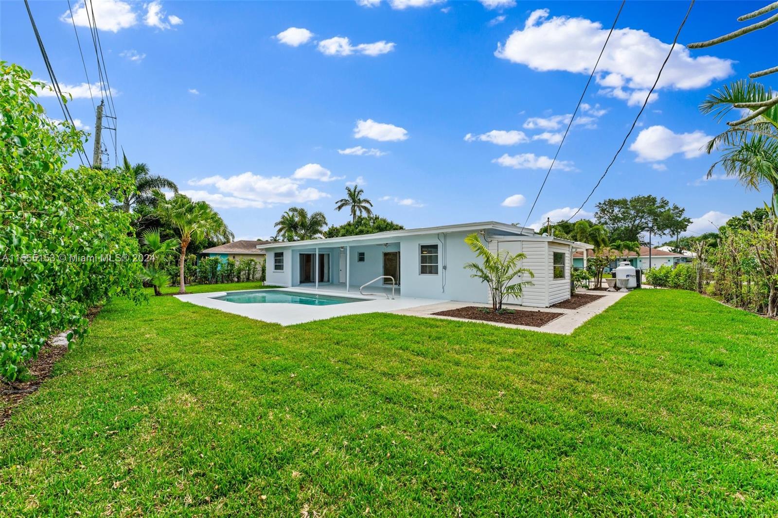 538 Dover Road Tequesta, FL 33469 - Photo 44 of 63 a view of a house with a chairs in a big yard