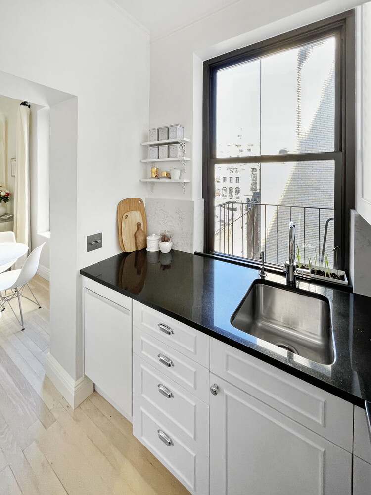 55 East 65th Street, Unit 7A Manhattan, NY 10065 - Photo 13 of 18 a kitchen with granite countertop a sink and a window