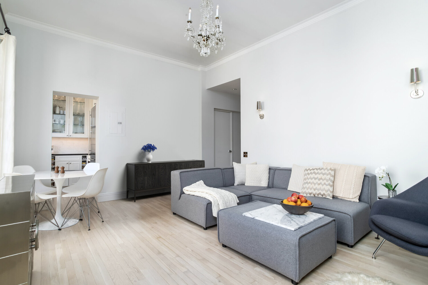 55 East 65th Street, Unit 7A Manhattan, NY 10065 - Photo 14 of 18 a living room with furniture and a table