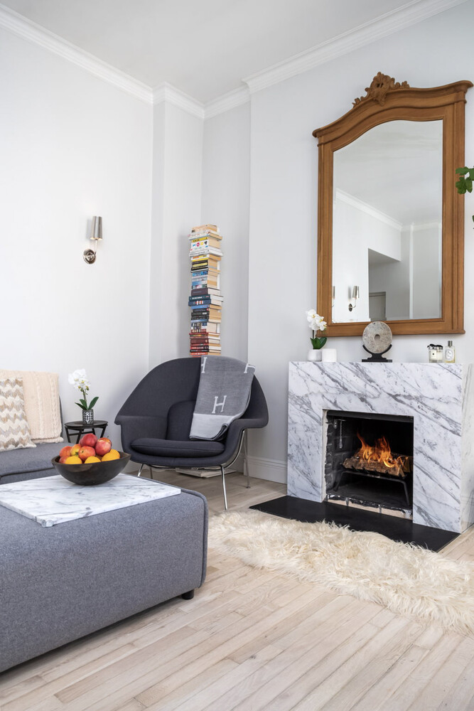 55 East 65th Street, Unit 7A Manhattan, NY 10065 - Photo 2 of 18 a living room with furniture and a fireplace