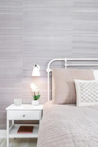 a bedroom with a bed wooden floor and flat screen tv