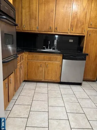 a kitchen with a sink a stove and a microwave oven in a cabinets