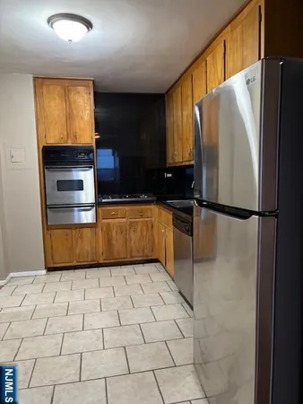 a kitchen with stainless steel appliances granite countertop a refrigerator sink and cabinets