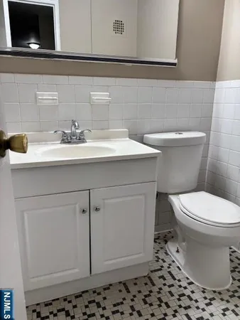 a bathroom with a sink toilet and vanity