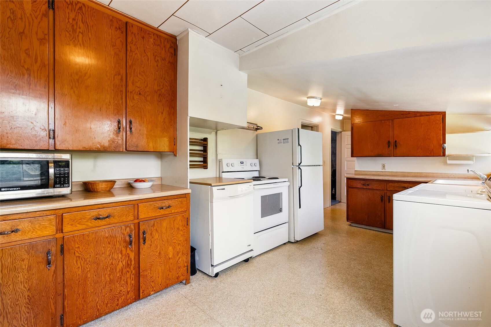 4535 Cable Street Bellingham, WA 98229 - Photo 12 of 31 a kitchen with cabinets and white appliances