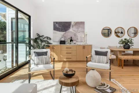 a living room with furniture and a floor to ceiling window