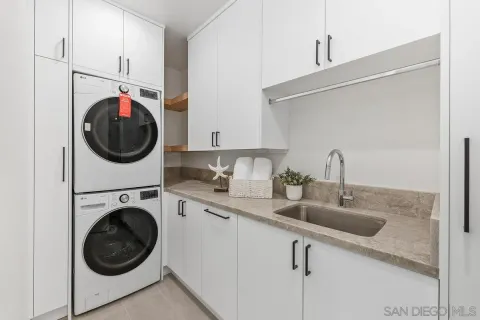 a utility room with sink dryer and washer