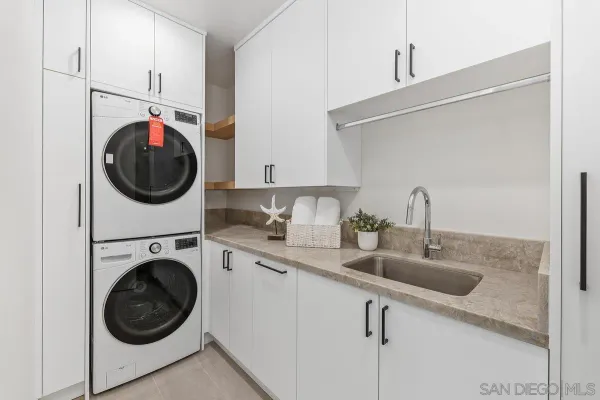 a utility room with sink dryer and washer
