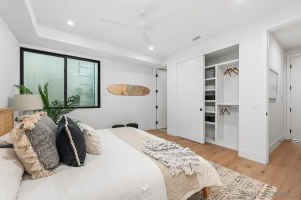a bedroom with a large bed and a large window