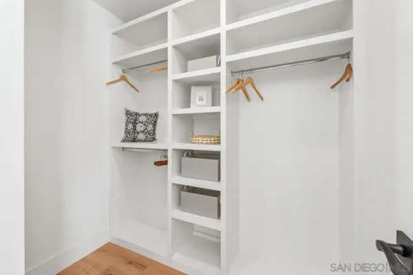 a view of walk in closet with empty racks