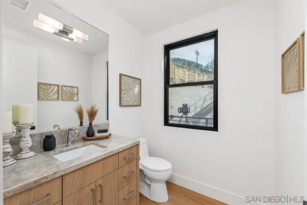 a bathroom with a toilet a sink and mirror