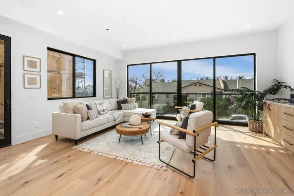 a living room with furniture and a floor to ceiling window