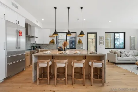 a kitchen with stainless steel appliances kitchen island granite countertop a sink and cabinets