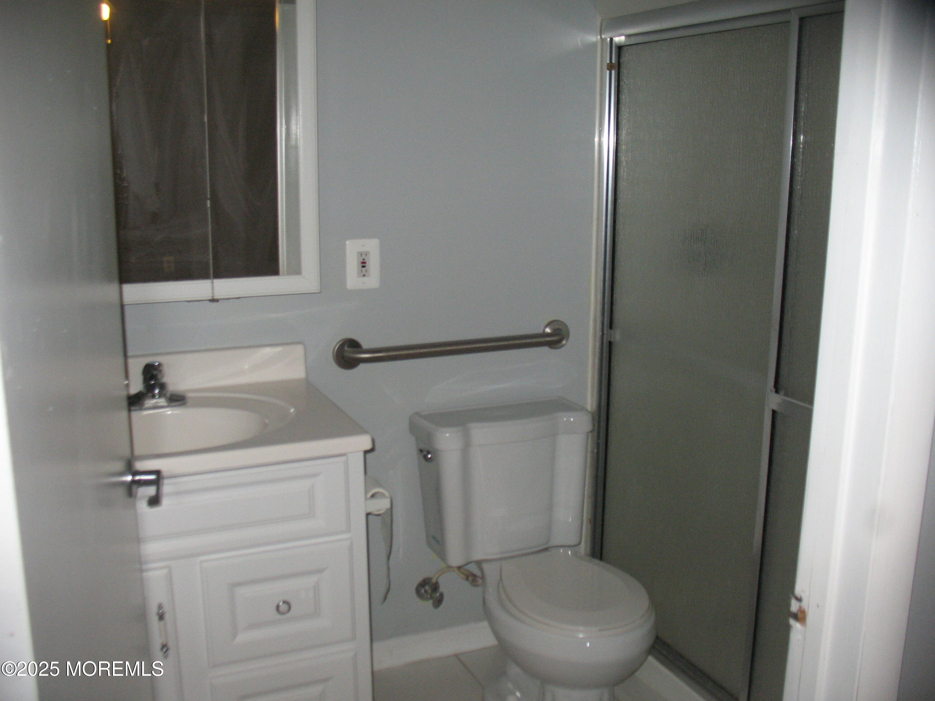 32 Appletree Road Howell, NJ 07731 - Photo 13 of 18 a bathroom with a toilet a sink and mirror