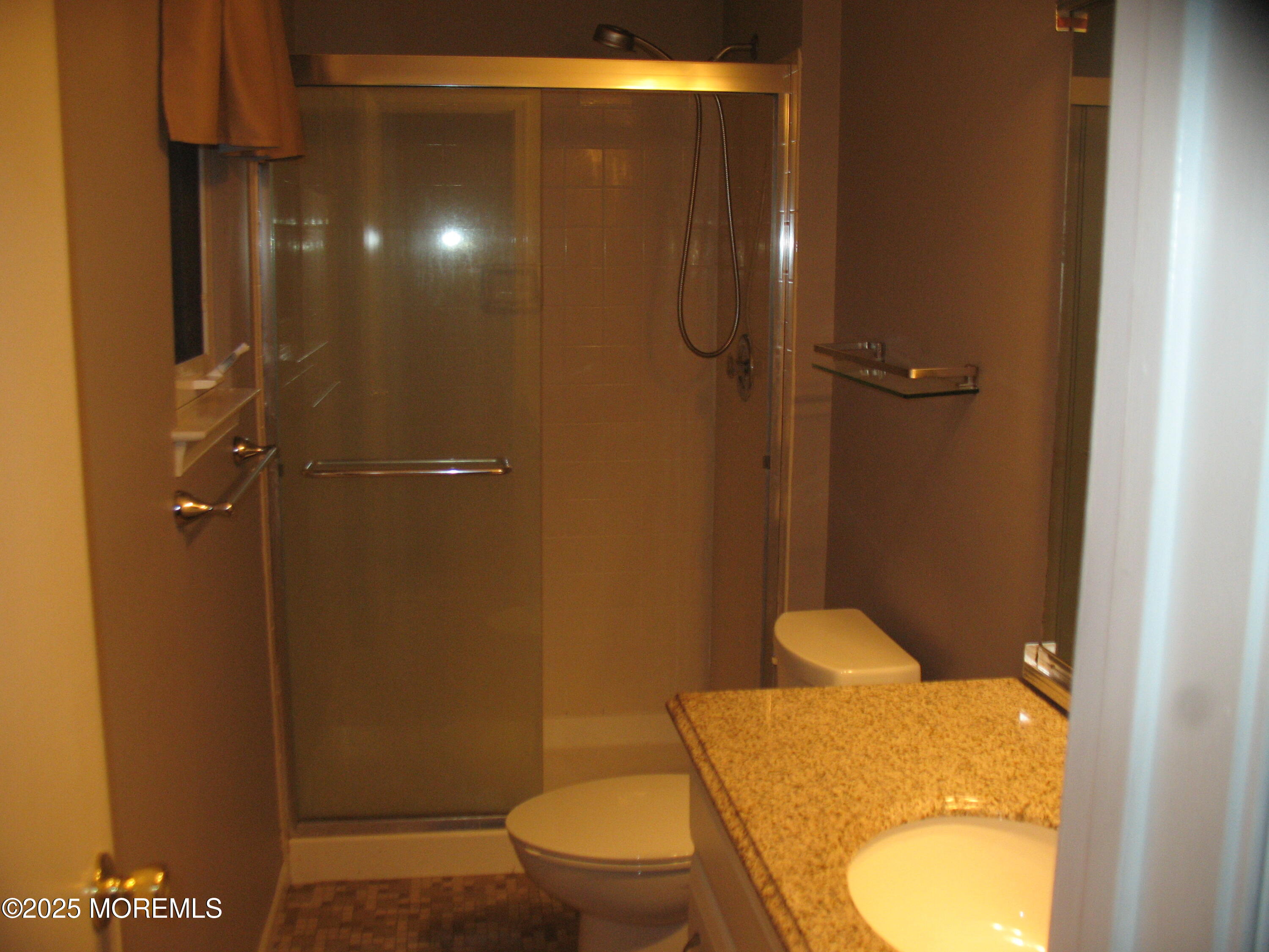 32 Appletree Road Howell, NJ 07731 - Photo 16 of 18 a bathroom with a granite countertop toilet and a shower