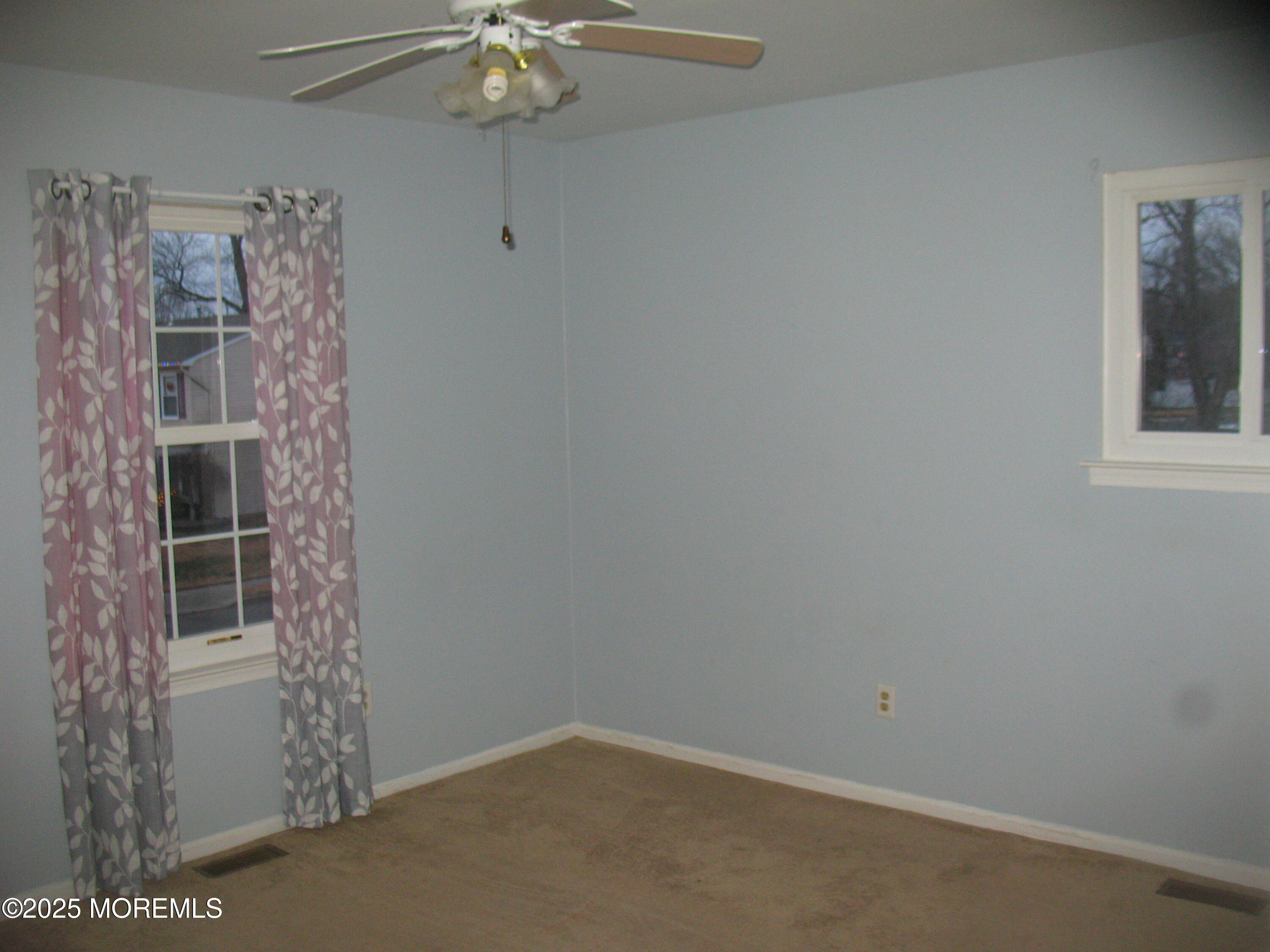 32 Appletree Road Howell, NJ 07731 - Photo 18 of 18 en empty room with window and chandelier fan