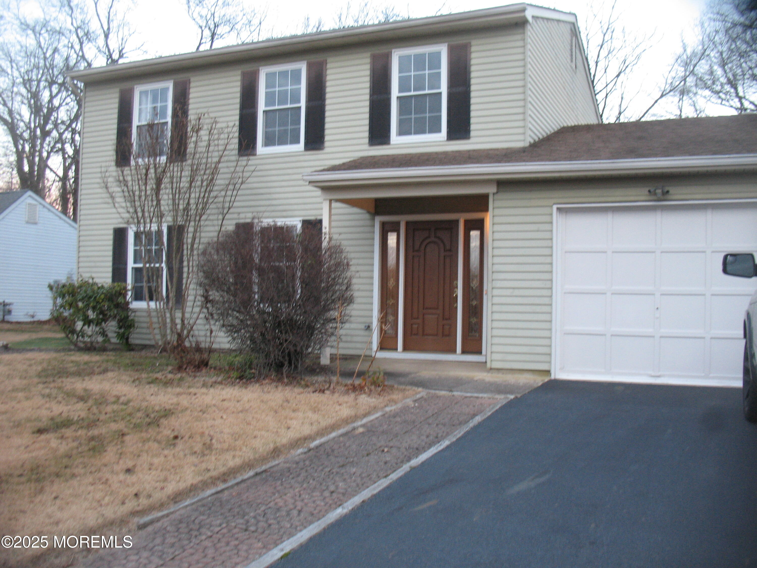 32 Appletree Road Howell, NJ 07731 - Photo 3 of 18 a front view of a house with a yard and garage