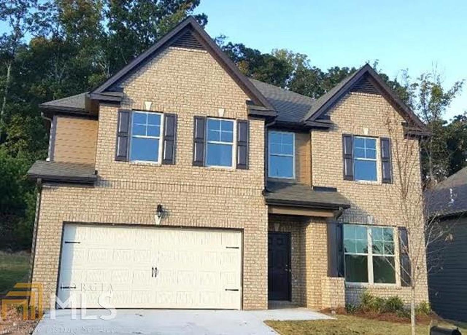 1376 Pebble Ridge Drive, Unit 174 Hampton, GA 30228 - Photo 1 of 1 a front view of a house with a yard and garage