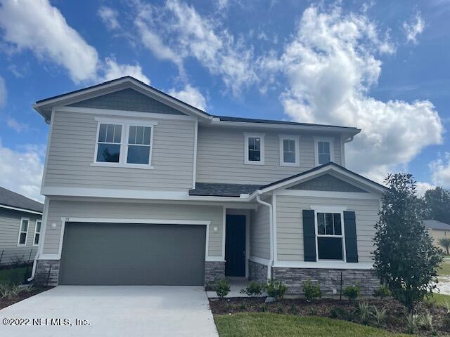 73 Wards Ravine Way St. Johns, FL 32259 - Photo 1 of 6 a front view of a house with garage