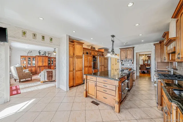 a view of a dining room with furniture a chandelier and wooden floor